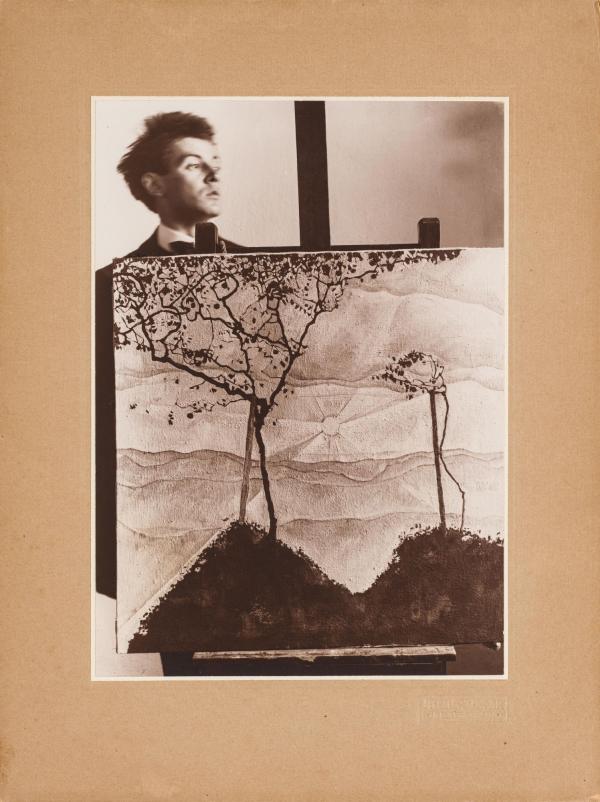 Egon Schiele hinter seinem auf einer Staffelei befindlichen Gemälde Herbstsonne I 